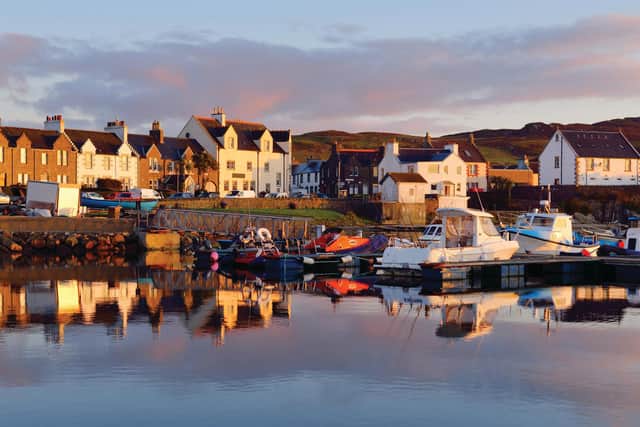 A view of the rocky shore of a small town Port Ellen at sunrise