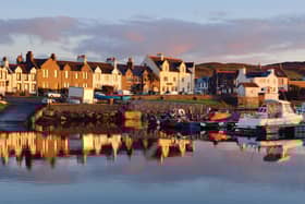 A view of the rocky shore of a small town Port Ellen at sunrise