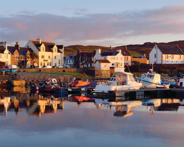 A view of the rocky shore of a small town Port Ellen at sunrise