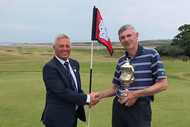 After facing each other in the final, Bob Humble, right, receives the Kilspindie club championship trophy from captain Chris Stirling. Picture: Kilspindie Golf Club