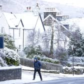 A man walks through the snow in Killin, Stirlingshire