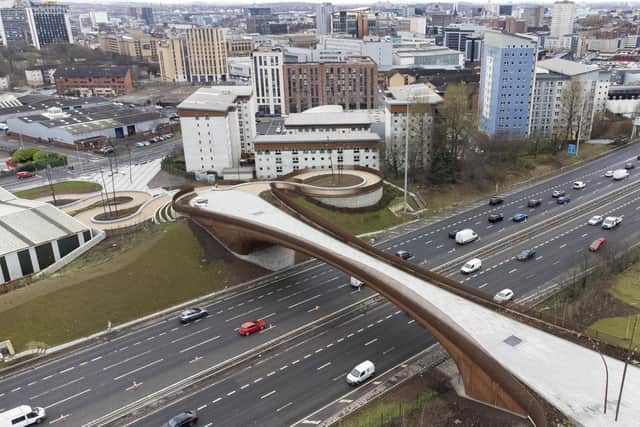 Cyclist, pedestrian and wheeler Sighthill Bridge over the M8. The project was part of the Glasgow City Region City Deal. Picture: John Devlin