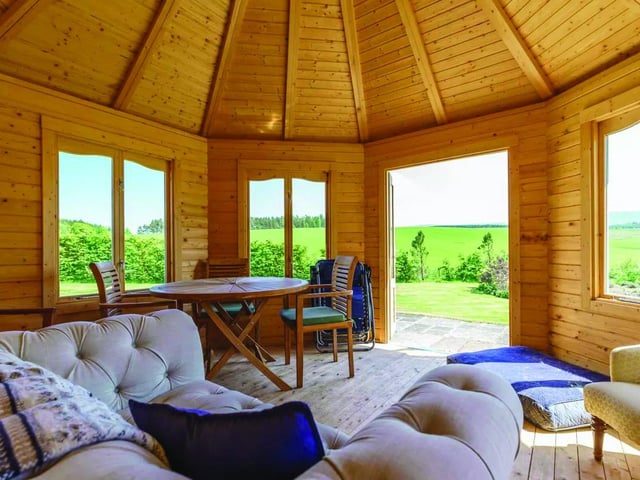 The summer house is more of a cabana, with space for eating and sitting in the shade. It is also well insulated, double-glazed, and has power so it is usable all year.