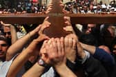 Christians in Jerusalem carry their large wooden cross along the route tradition says Jesus carried the cross on, to mark Good Friday