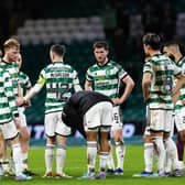 Celtic's Callum McGregor tries to lift the spirits of his team-mates after losing to Hearts.