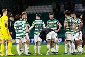 Celtic's Callum McGregor tries to lift the spirits of his team-mates after losing to Hearts.