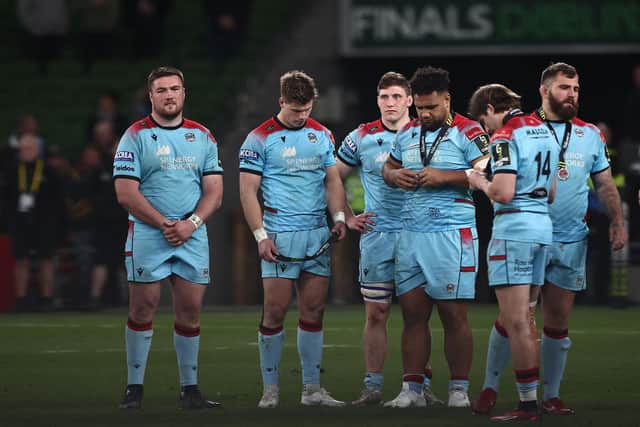 The dejected Glasgow Warriors players look at their medals following the 43-19 defeat by Toulon in Dublin.