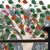 Senior charge nurse Rosario Walshe beside a Remembrance Tree mural that has been installed as a backdrop on one of the full-length windows in the ward. Picture: Andrew Milligan/PA Wire