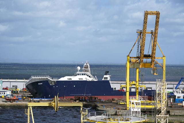 Emergency services at Imperial Dock in Leith, Edinburgh, where a ship has become dislodged from its holding and is partially toppled over. Picture date: Wednesday March 22, 2023.