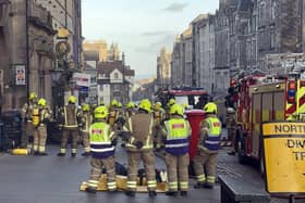 Firefighters attend to a fire on the Royal Mile in Edinburgh, Scotland in February