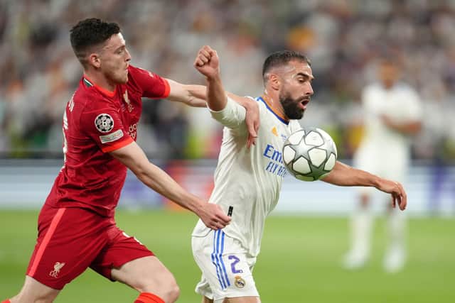 Scotland captain Andy Robertson, pictured up against Karim Benzema, played for Liverpool.