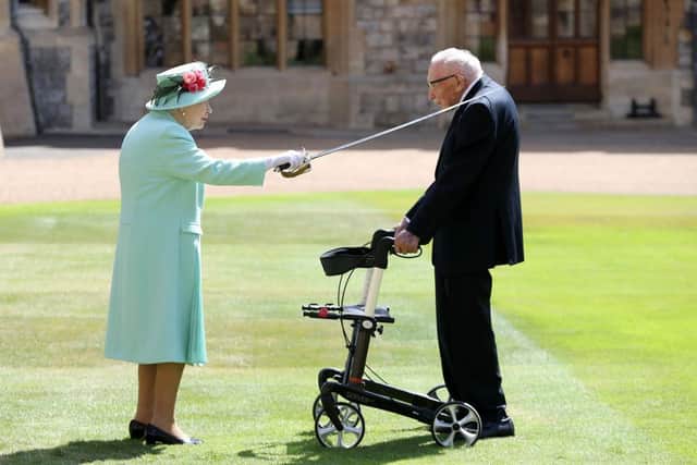 Queen Elizabeth II awards Captain Sir Thomas Moore with the insignia of Knight Bachelor at Windsor Castle on July 17, 2020 in Windsor, England. British World War II veteran Captain Tom Moore raised over £32 million for the NHS during the coronavirus pandemic.  (Photo by Chris Jackson/Getty Images)