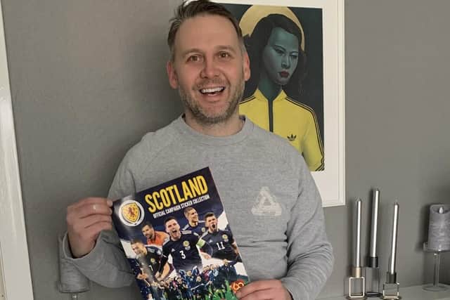 Mark McMullan with his sticker album