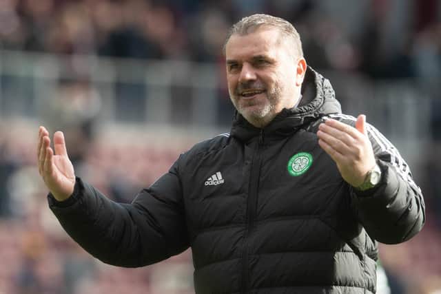 Ange Postecoglou celebrates with the Celtic fans after the victory over Hearts.