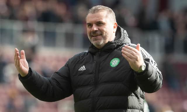 Ange Postecoglou celebrates with the Celtic fans after the victory over Hearts.