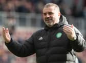 Ange Postecoglou celebrates with the Celtic fans after the victory over Hearts.
