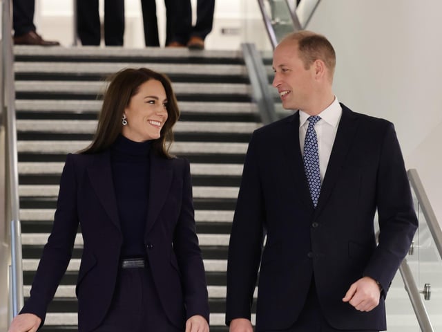 The royal couple emerge at Logan International Airport.