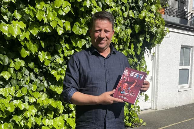 Former manager Paulo Sergio with Anthony Brown's book about Hearts' 5-1 over Hibs in the Scottish Cup final in 2012. It proved to be his last match in charge of the Tynecastle club