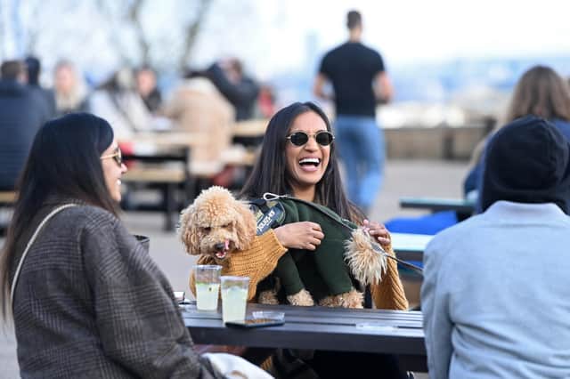 People enjoy a drink outside Alexandra Palace in London yesterday after lockdown restrictions in England were relaxed (Picture: Kate Green/Getty Images)