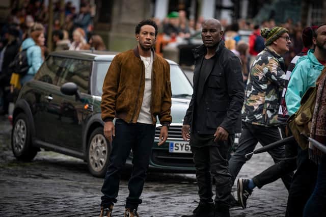 Tej (Chris “Ludacris” Bridges) and Roman (Tyrese Gibson) film F9, directed by Justin Lin, on the Royal Mile