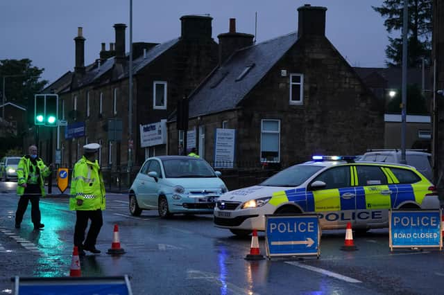 Police at the scene of the car crash on James Street in Carluke, South Lanarkshire.