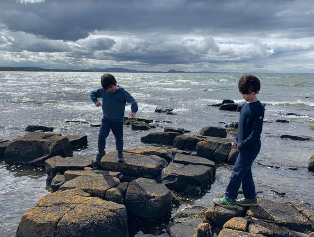 The boys playing together at the beach.