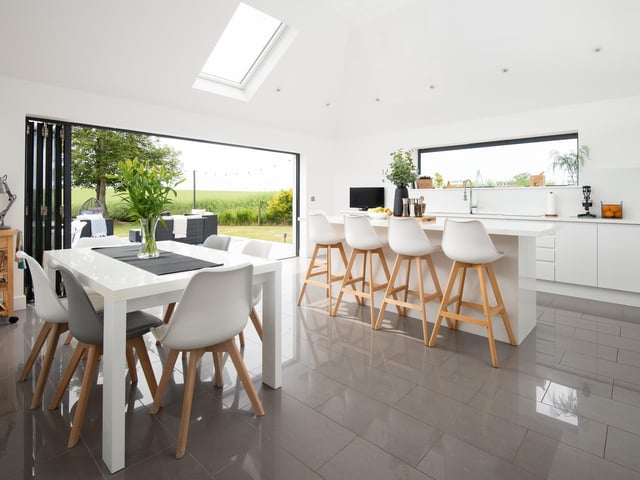 Interior: A welcoming porch leads to a drawing room, family room and sitting room, while the heart of the home is a contemporary open-plan kitchen-diner with bi-folding doors opening out onto a well-kept garden.
