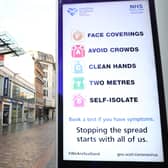 File photo of a coronavirus advice sign outside Argyle Street station in Glasgow.