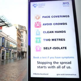 File photo of a coronavirus advice sign outside Argyle Street station in Glasgow.