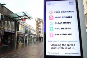 File photo of a coronavirus advice sign outside Argyle Street station in Glasgow.