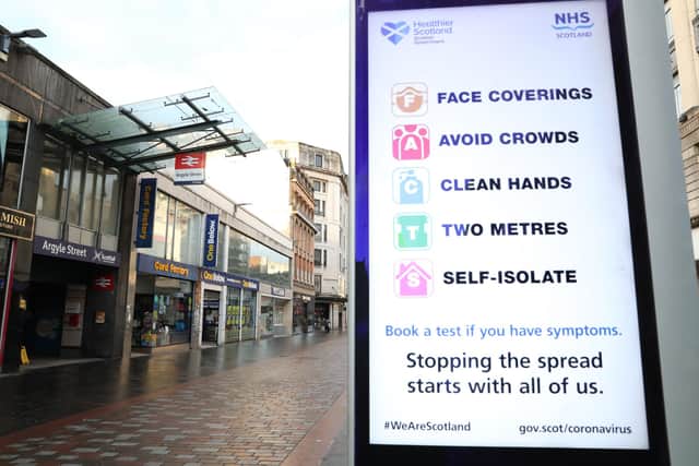 File photo of a coronavirus advice sign outside Argyle Street station in Glasgow.