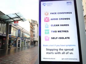 File photo of a coronavirus advice sign outside Argyle Street station in Glasgow.