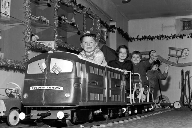 Children play on the model of the Golden Arrow engine in Jenners department store, in Edinburgh, in 1965