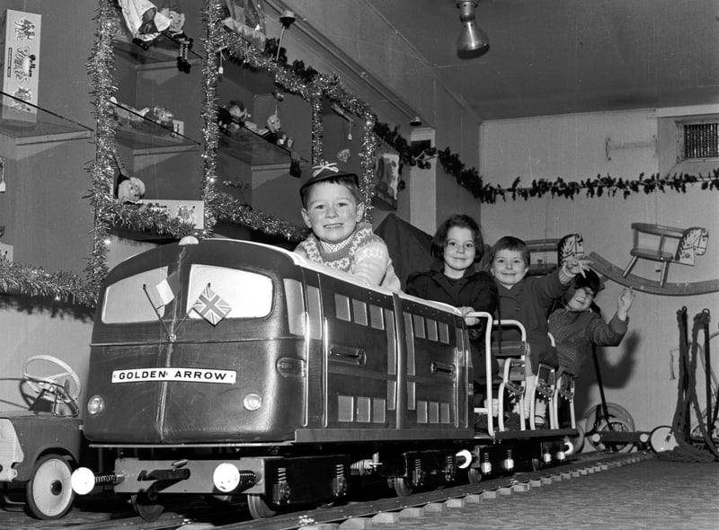 Children play on the model of the Golden Arrow engine in Jenners department store, in Edinburgh, in 1965