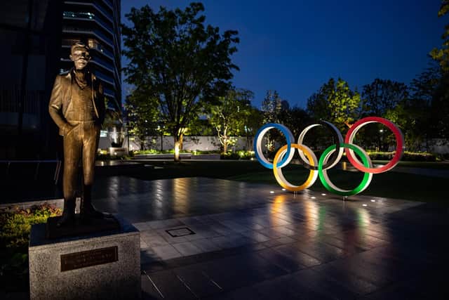 A bronze statue of Pierre de Coubertin (L), founder of the International Olympic Committee and the Olympic Rings are displayed at Japan Sport Olympic Square in Tokyo on April 20, 2020. - A Japanese expert who has criticised the country's response to the coronavirus warned on April 20 that he is "pessimistic" that the postponed Olympics can be held even in 2021. (Photo by Philip FONG / AFP) (Photo by PHILIP FONG/AFP via Getty Images)