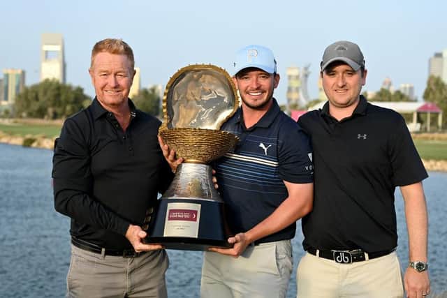 Ewen Ferguson celebrates his maiden DP World Tour win with coach Jamie Gough, left, and caddie Stephen Neilson, right. Picture: Stuart Franklin/Getty Images.