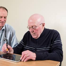 Prof Richard Walker, clinical lead adviser to Edinburgh-based Manus Neurodynamica, pictured with a patient, prior to Covid measures.