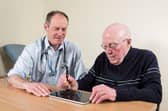Prof Richard Walker, clinical lead adviser to Edinburgh-based Manus Neurodynamica, pictured with a patient, prior to Covid measures.