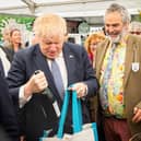 Boris Johnson buying a bottle of wine at the Royal Cornwall show at Whitecross near Wadebridge. Picture PA Wire