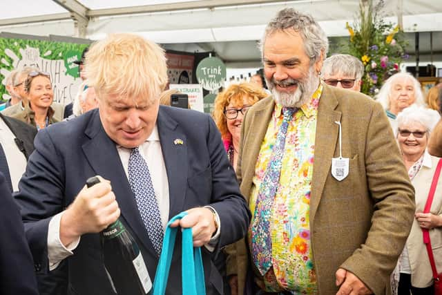 Boris Johnson buying a bottle of wine at the Royal Cornwall show at Whitecross near Wadebridge. Picture PA Wire