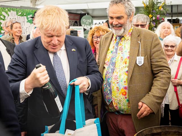 Boris Johnson buying a bottle of wine at the Royal Cornwall show at Whitecross near Wadebridge. Picture PA Wire