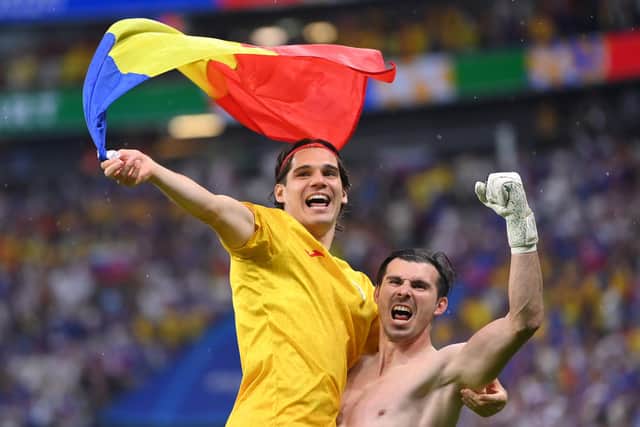 Rangers forward Ianis Hagi and Romania team-mate Florin Nita celebrate with a Romania national flag after the team's qualification to the knockout stages. (Photo by Justin Setterfield/Getty Images)