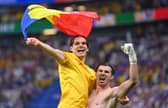 Rangers forward Ianis Hagi and Romania team-mate Florin Nita celebrate with a Romania national flag after the team's qualification to the knockout stages. (Photo by Justin Setterfield/Getty Images)