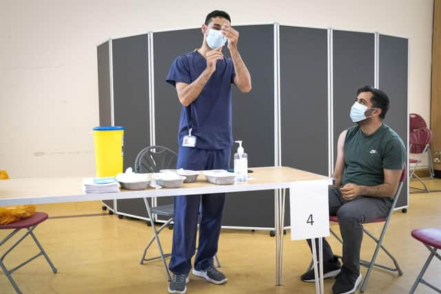 Health secretary Humza Yousaf receives his second dose of the BioNTech Pfizer Covid-19 vaccine administered by vaccinator Arhum Asif at the Glasgow Central Mosque. Picture: Jane Barlow/PA Wire