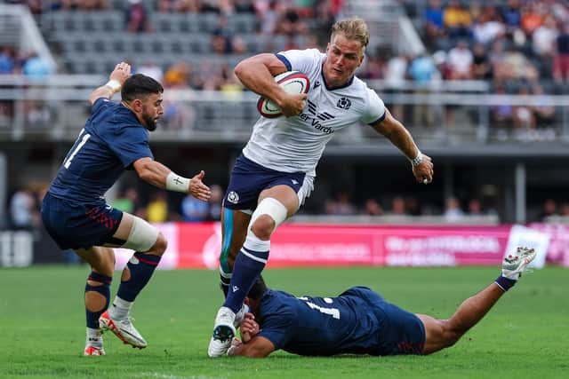 Duhan van der Merwe avoids the tackle attempts of USA's Nate Augspurger (11) and Tavite Lopeti (13) at Audi Field in Washington DC to score the try which equalled Stuart Hogg's all-time Scotland try record. (Photo by Scott Taetsch/Getty Images for Scottish Rugby)