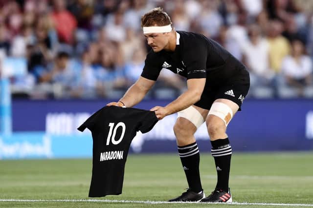Sam Cane of the All Blacks lays down a No 10 jersey in memory of Diego Maradona prior to the Tri-Nations match against Argentina. Picture: Brendon Thorne/Getty Images