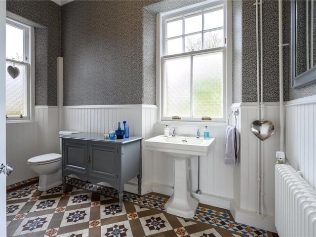 Ground floor cloakroom with mosaic tiled floor.