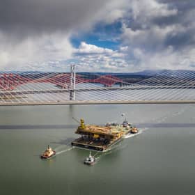 Aerial image of the Iron Lady barge with its cargo of a topside drilling platform for decommissioning being towed by Forth Ports tugs at the Forth Bridges into The Port of Rosyth on Sunday, April 11. Credit: Airbourne Lens