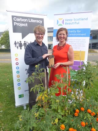 Russell Gill and Catherine Gee with Keep Scotland Beautiful’s Carbon Literate Organisation award