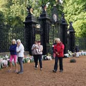 Mourners gather to lay flowers and pay their respects at the Sandringham Estate in Norfolk following the death of Queen Elizabeth II on Thursday. Picture date: Friday September 9, 2022.